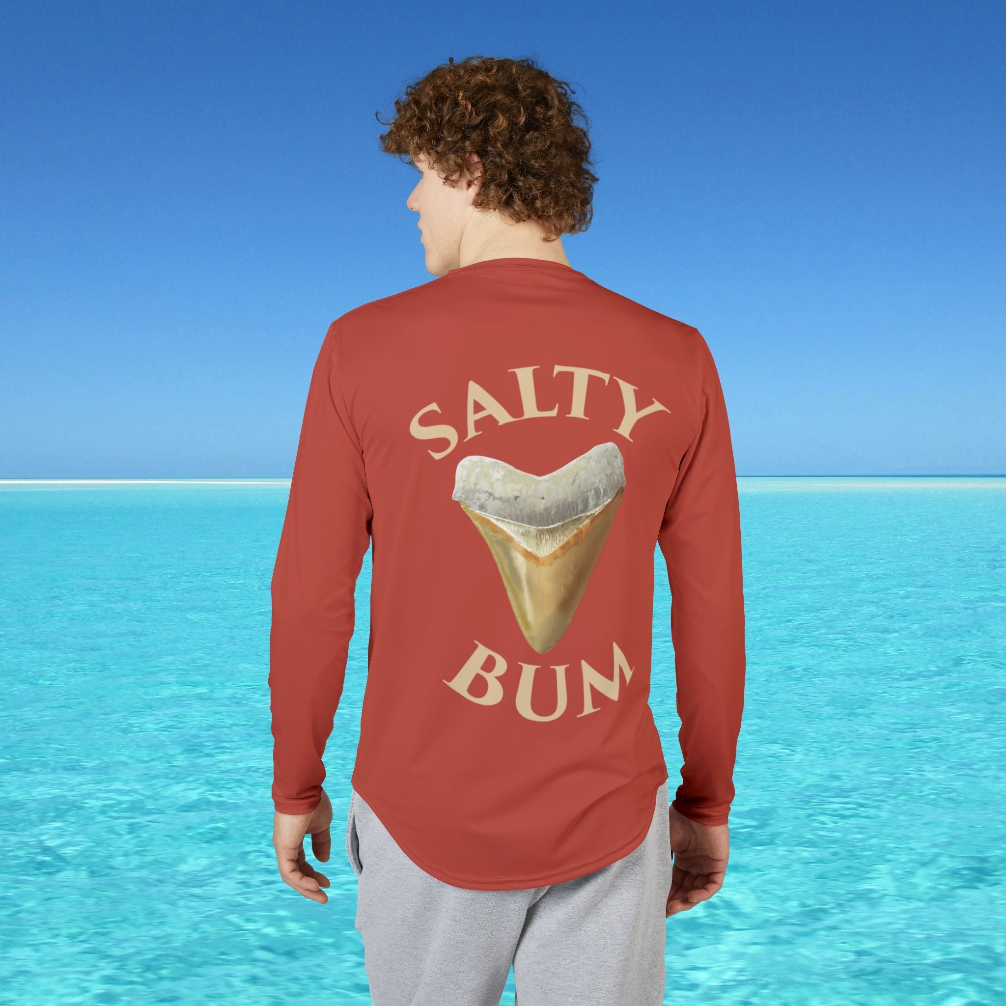 man wearing red salty bum shirt with tooth