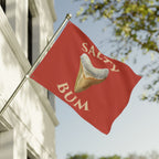 Red flag with a fortune cookie graphic and 'Salty Bum' text, waving in front of a building.