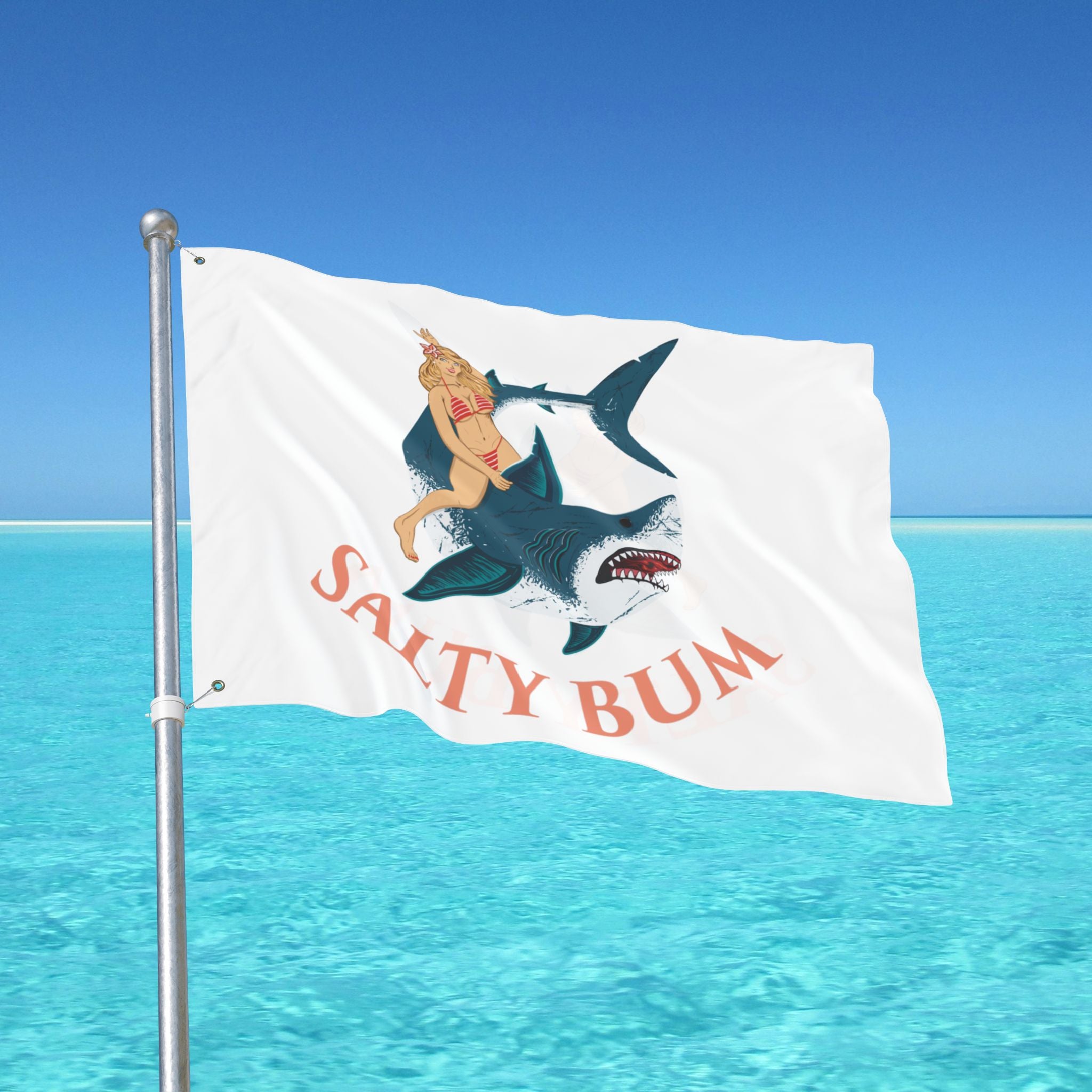 Flag with a graphic design of a woman on a shark and 'Salty Bum' text against a blue sky and ocean background.