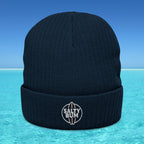 Navy blue beanie with 'Salty Bum' logo on a blue water background