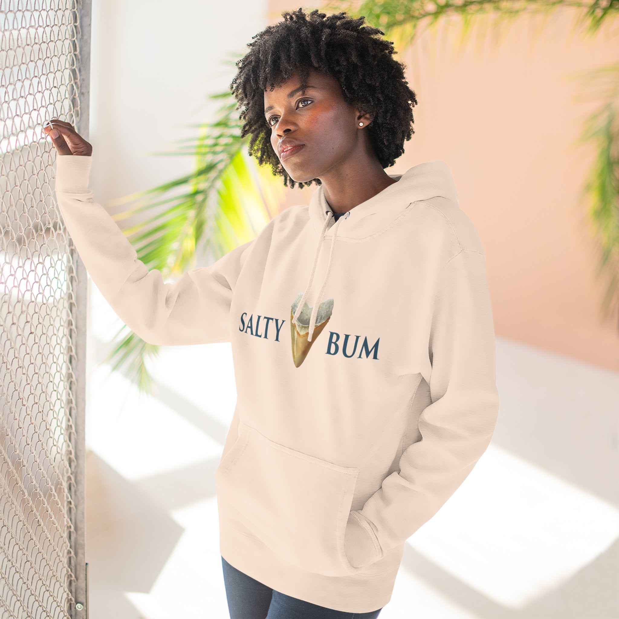 Person wearing a beige hoodie with 'Salty Bum' text and ice cream graphic, standing against a light background.