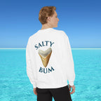 Person wearing a white sweatshirt with 'Salty Bum' text and an ice cream cone graphic, standing against a clear blue sky and ocean.