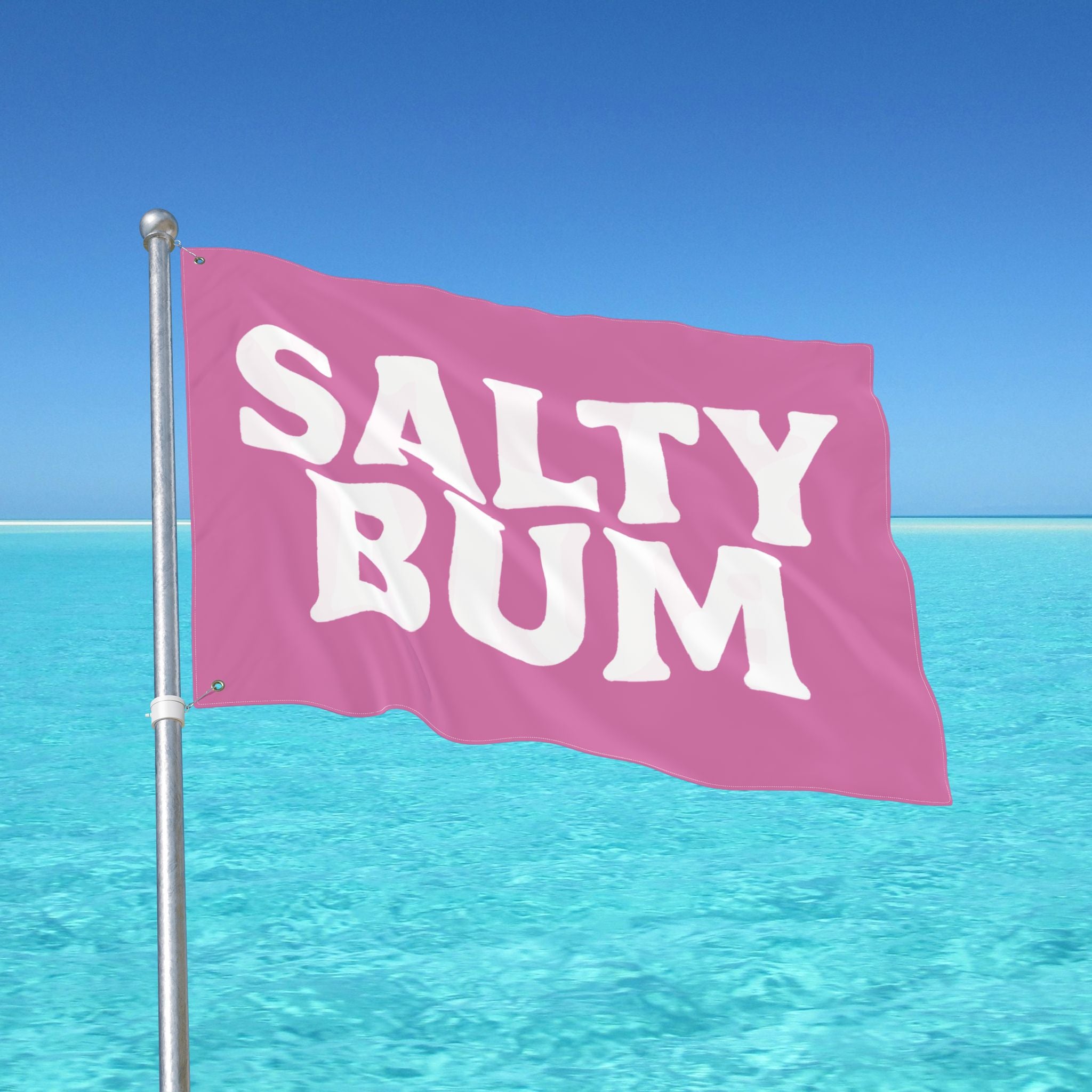 Pink flag with 'Salty Bum' text against a clear blue sky and ocean.