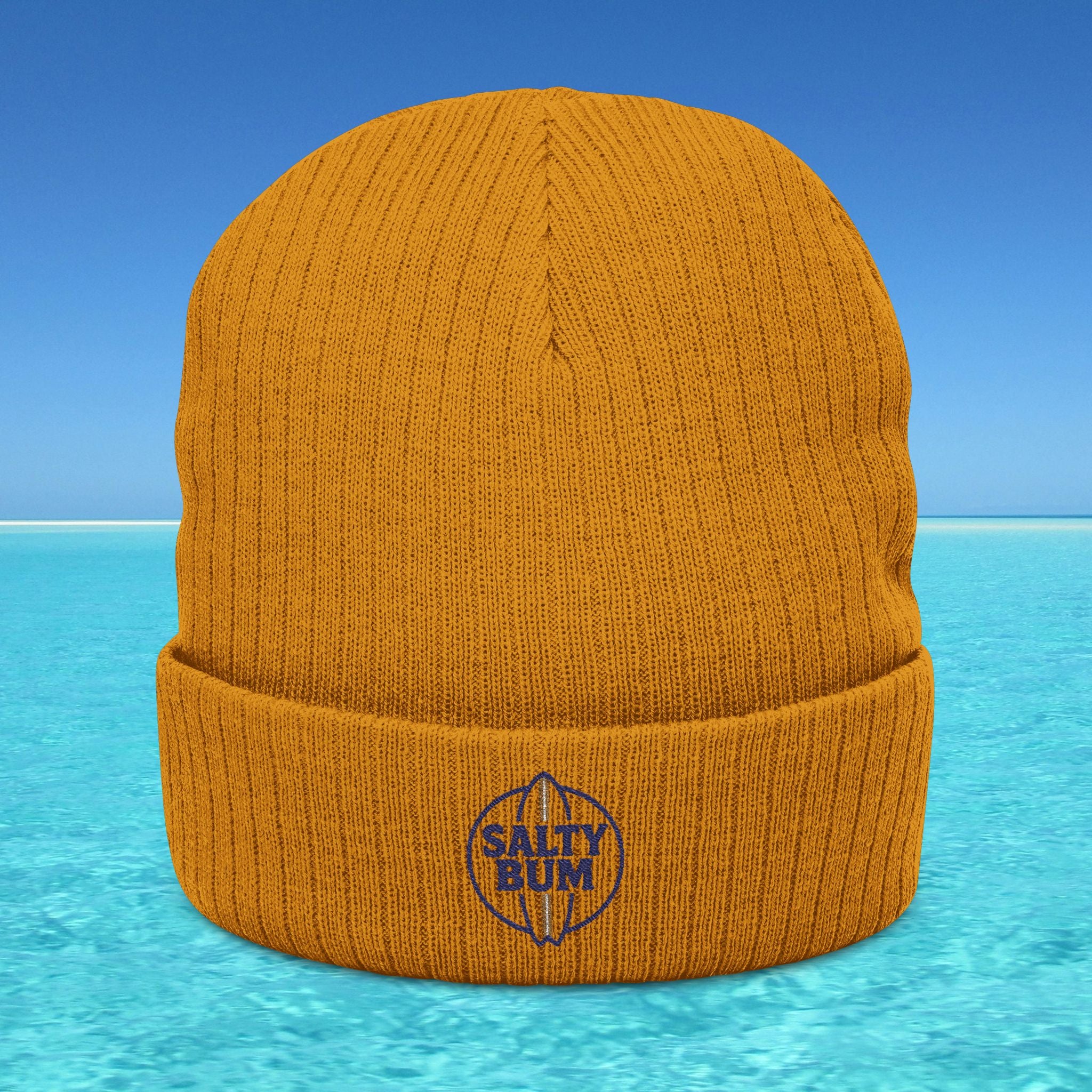 Orange beanie with 'Salty Bum' logo on a blue water and sky background