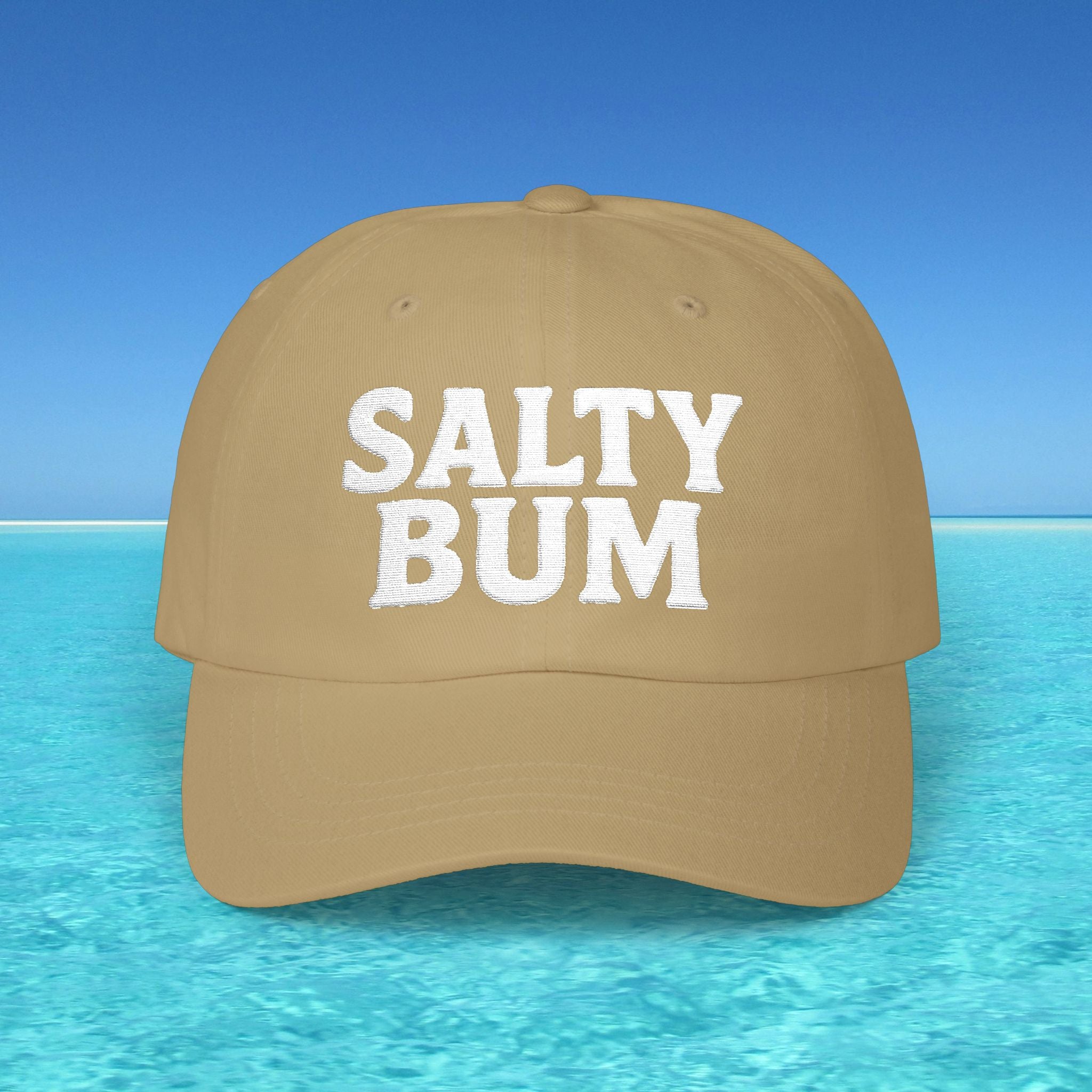 Brown cap with 'Salty Bum' text on a beach background