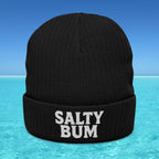 Black beanie with 'Salty Bum' text on a blue water and sky background