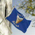 Blue flag with 'Salt Bum' logo featuring a corned beef hash bun on a building facade.