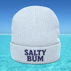 White beanie with 'Salty Bum' text on a blue water background
