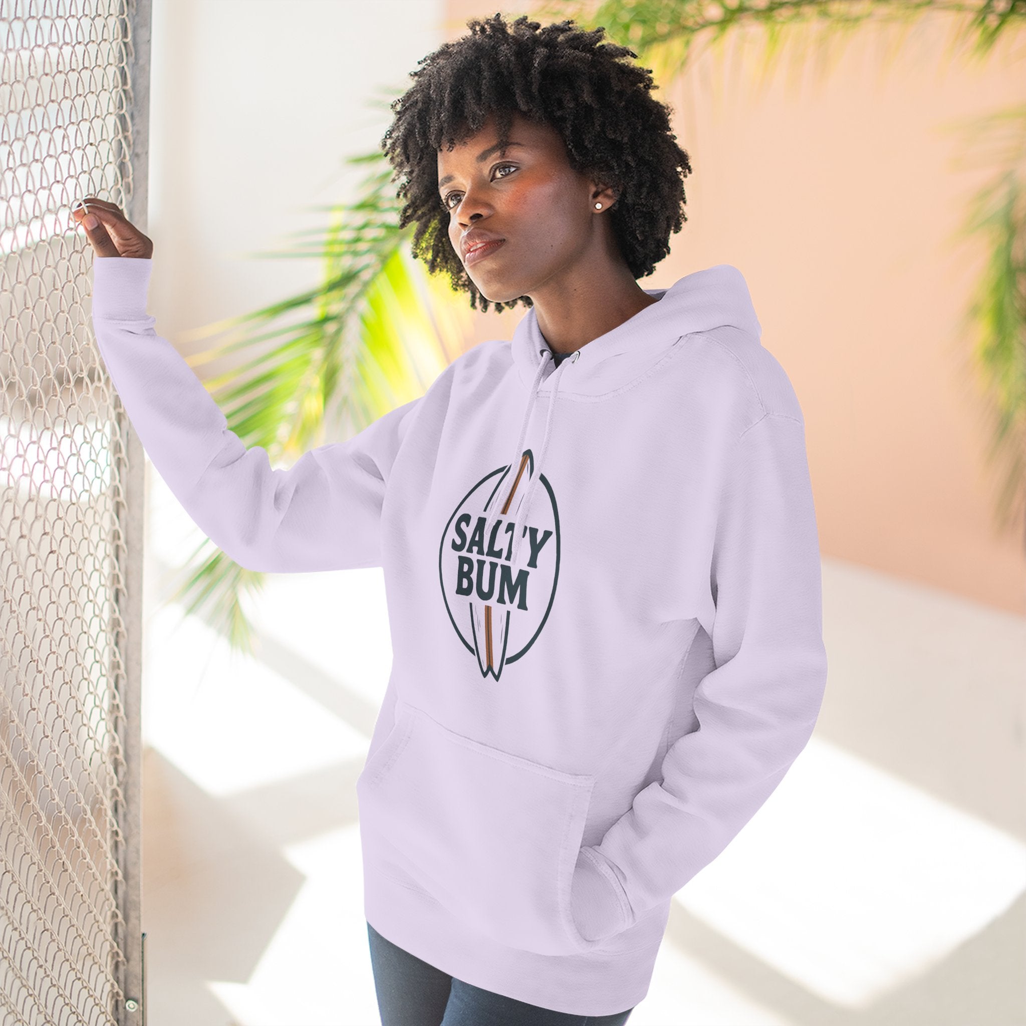 Person wearing a light purple hoodie with 'Salty Bum' logo, standing against a neutral background.