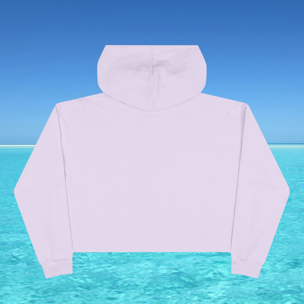 White hoodie against a blue sky and turquoise water background