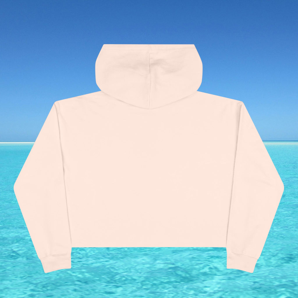 Beige hoodie against a blue sky and water background