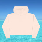 Beige hoodie against a blue sky and water background