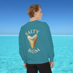 Person wearing a teal sweatshirt with 'Salty Bum' text and ice cream cone graphic, standing in front of a blue ocean.