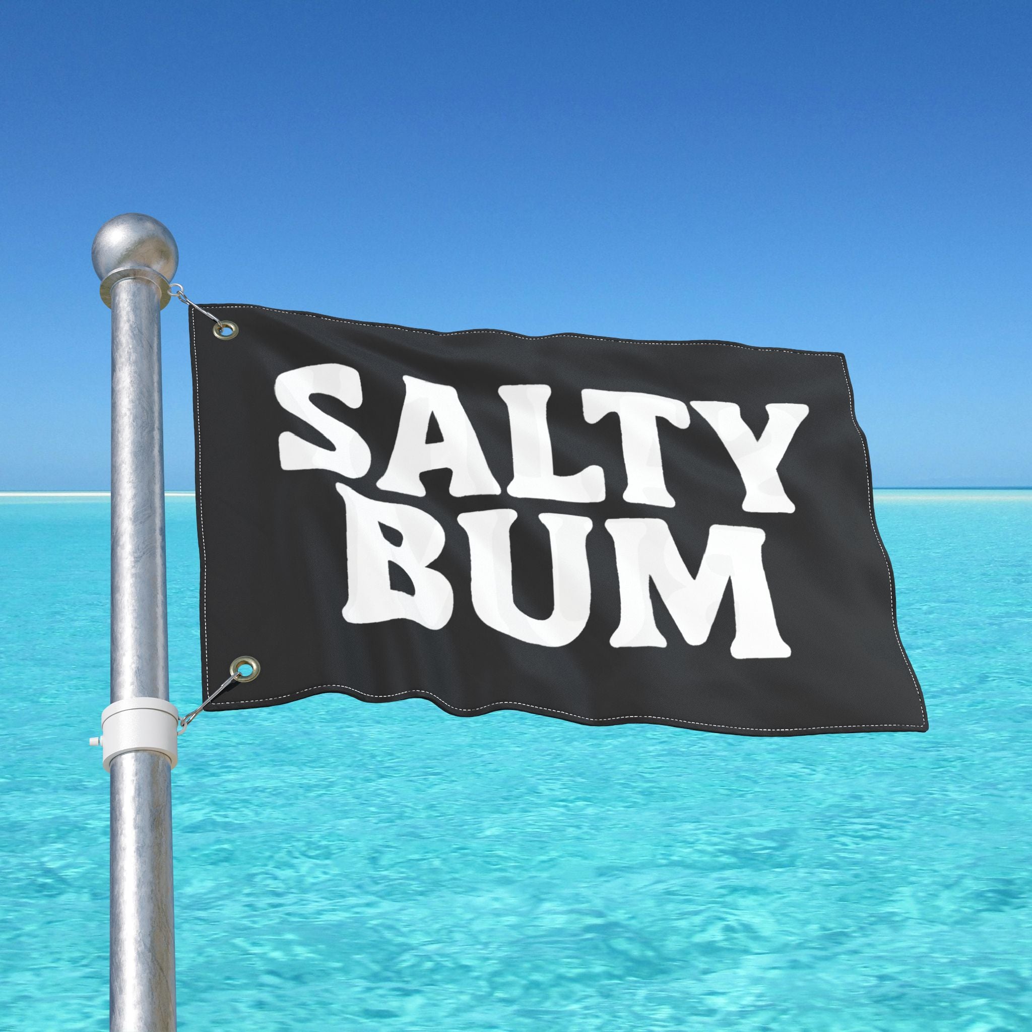 Flag with 'Salty Bum' text against a clear blue sky and ocean.