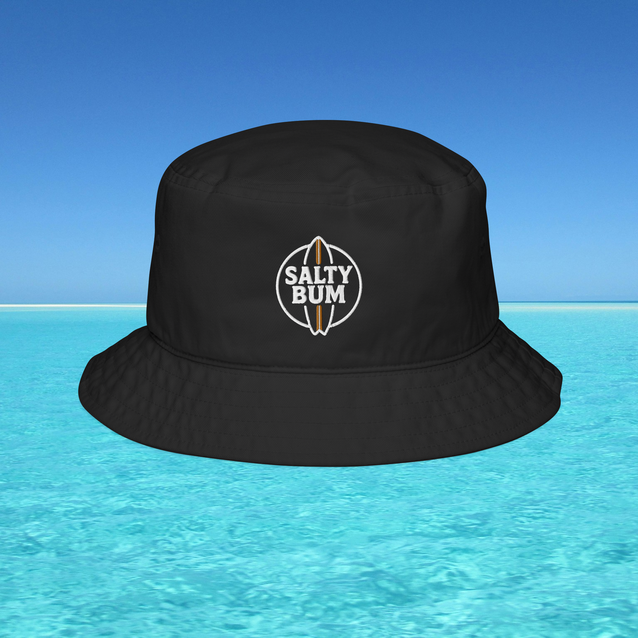 Black bucket hat with 'Salty Bum' logo on a blue water background
