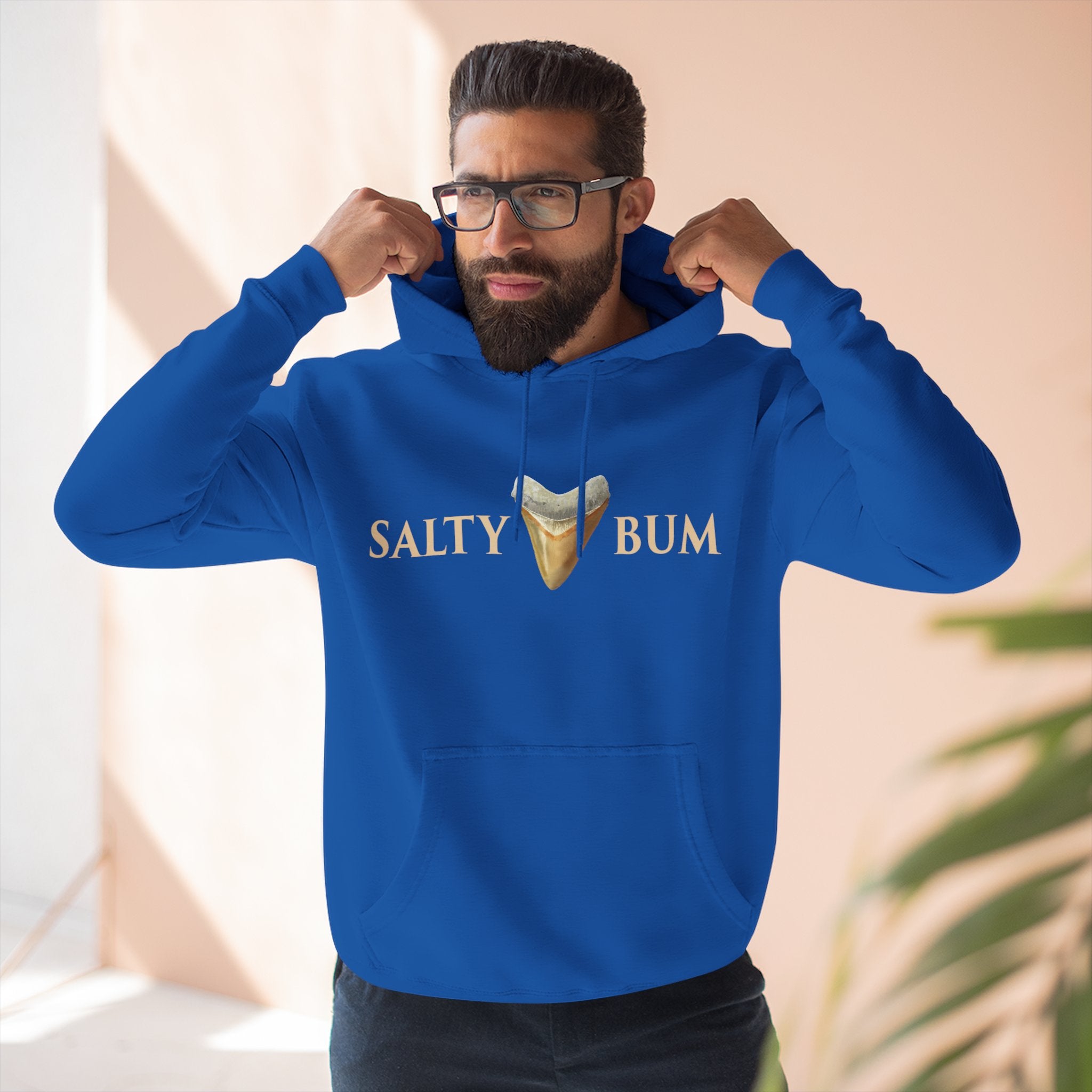 Man wearing a blue hoodie with 'Salty Bum' text and ice cream graphic.