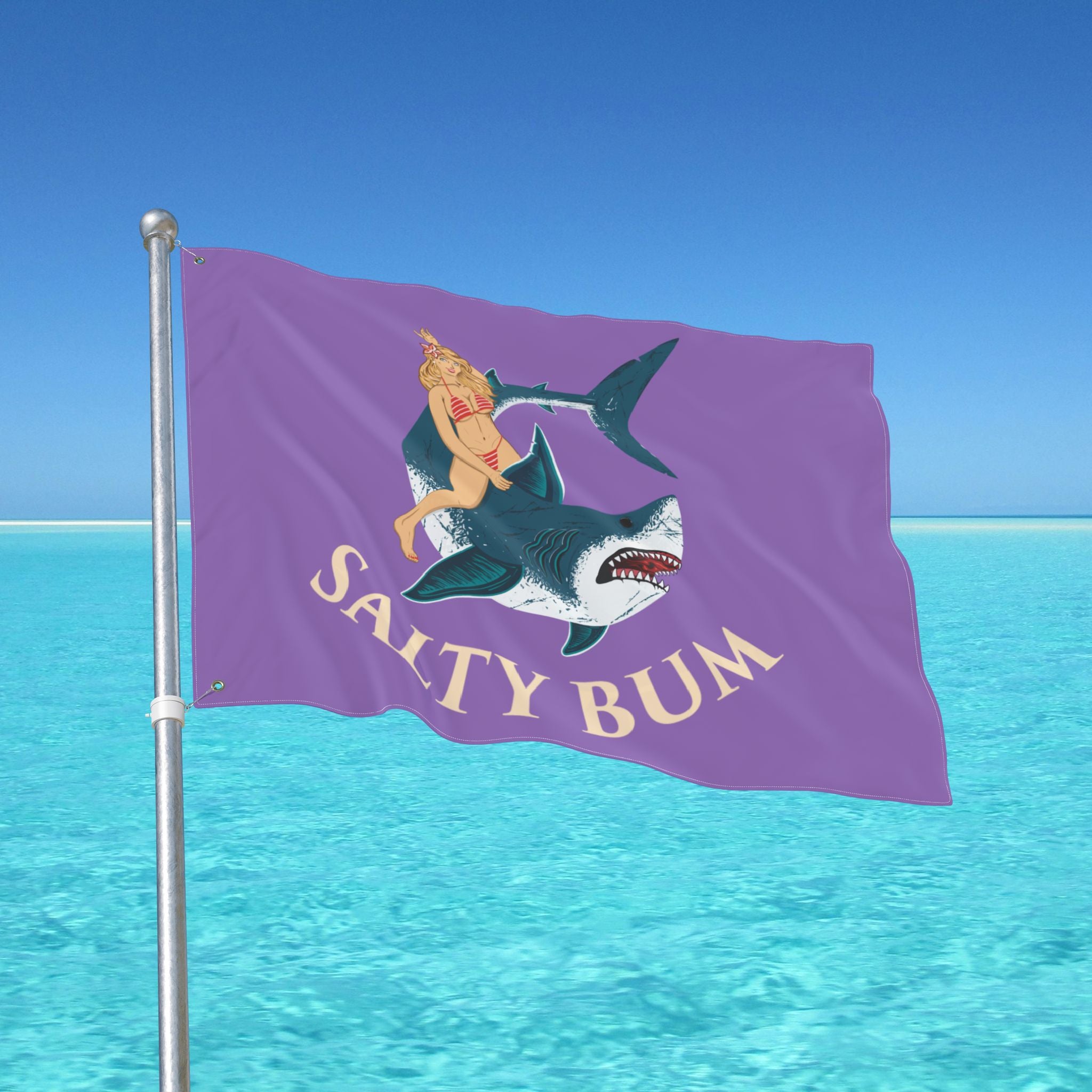 Flag with a shark and bikini-clad figure design against a blue ocean background
