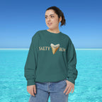Person wearing a green sweatshirt with 'Salty Bum' text and ice cream graphic against a blue ocean background