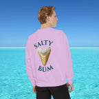 Person wearing a pink sweatshirt with 'Salty Bum' text and ice cream graphic, standing against a blue water and sky background.
