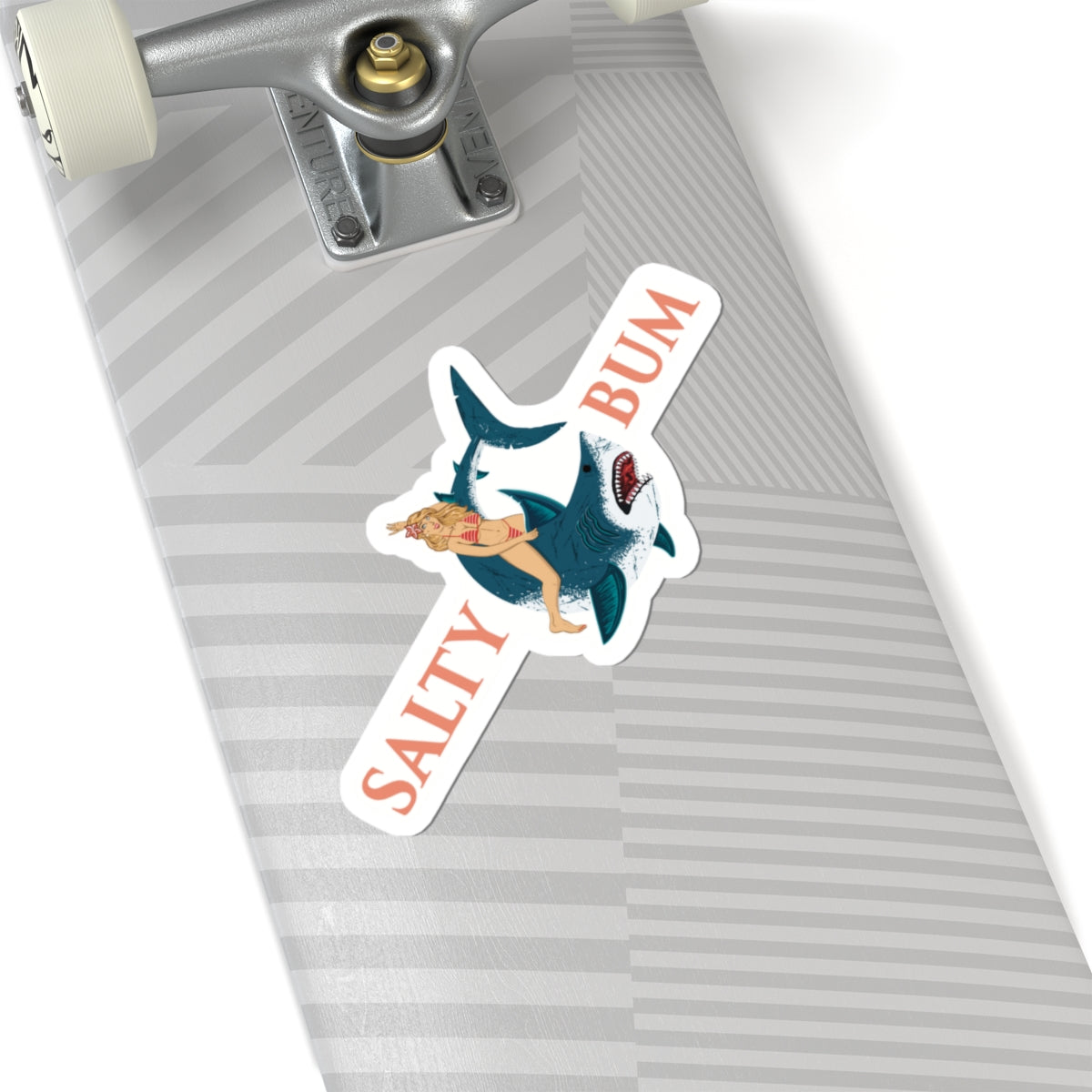 Skateboard with a sticker featuring a shark and a person, labeled 'Salty Bum', on a white background.