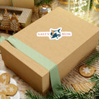 Wooden gift box with a green ribbon and 'Salty Bum' sticker on a festive background with cookies and lights.