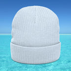 Gray beanie on a clear blue water background