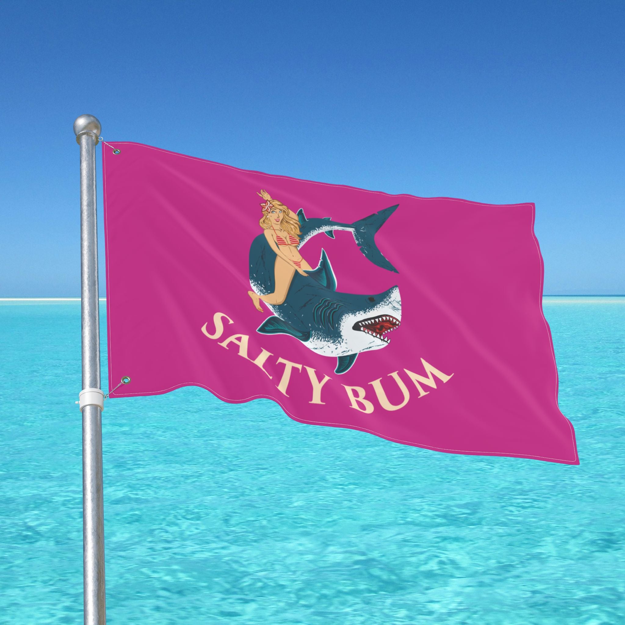 Flag with 'Salty Bum' design on a pole against a blue sky and ocean background