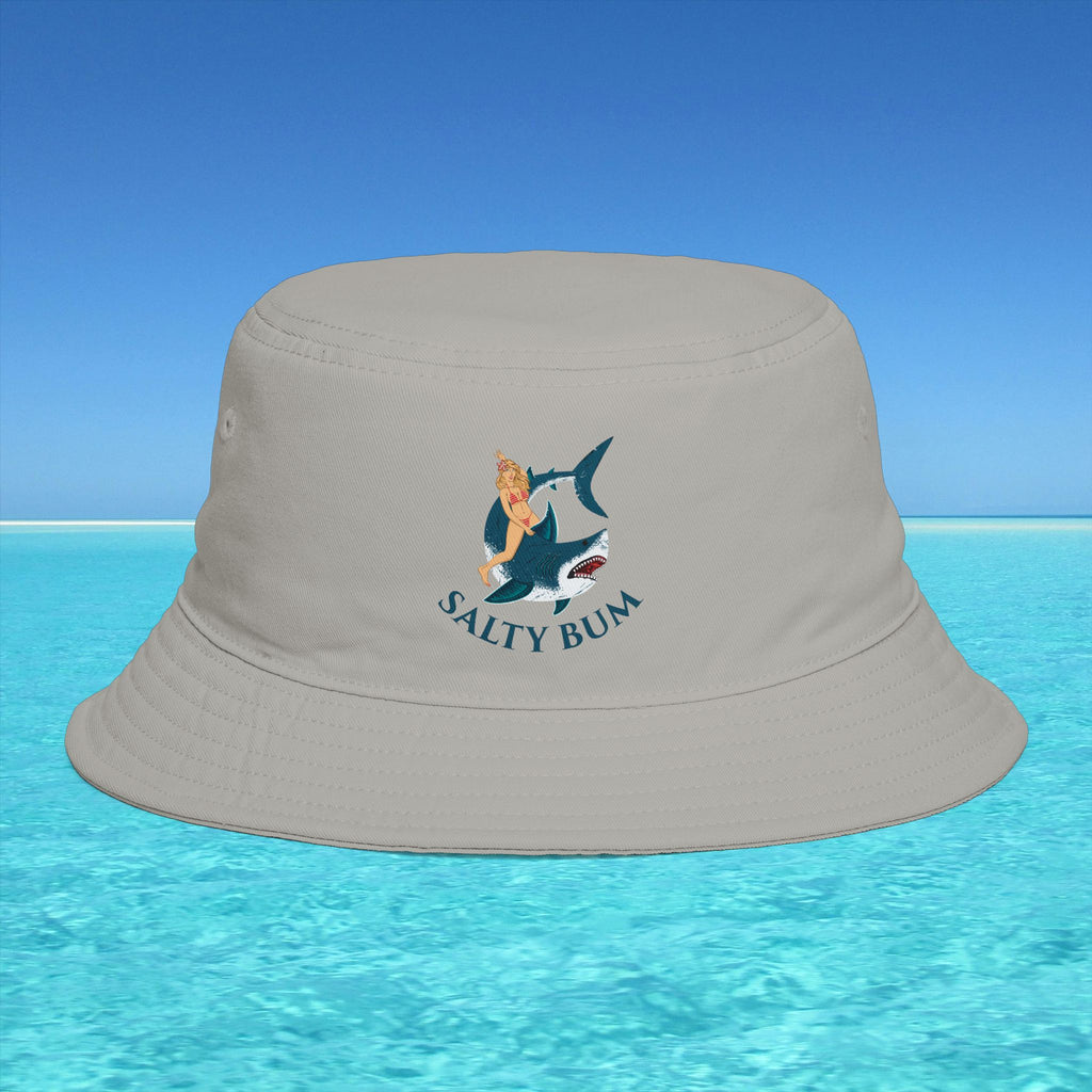 Beige bucket hat with 'Salty Bum' logo on a blue water and sky background