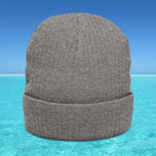 Gray knit beanie on a blue water background