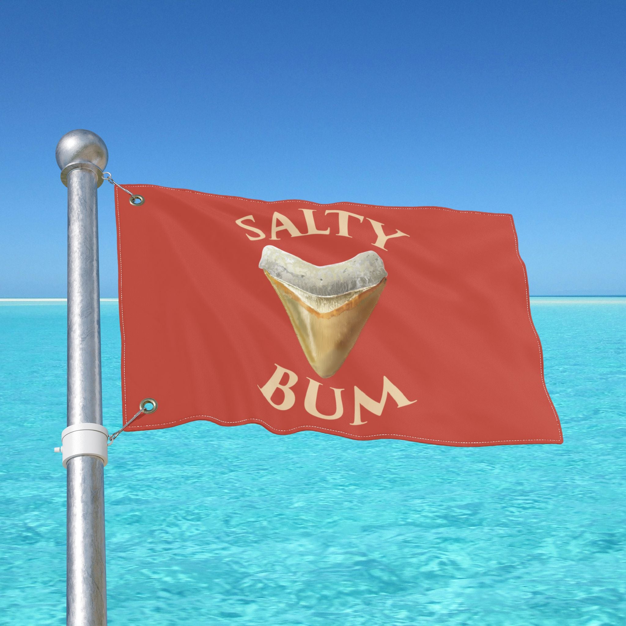 Flag with 'Salty Bum' text and a shark tooth graphic against a blue ocean and sky background.