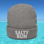 Gray beanie with 'Salty Bum' text on a blue water and sky background