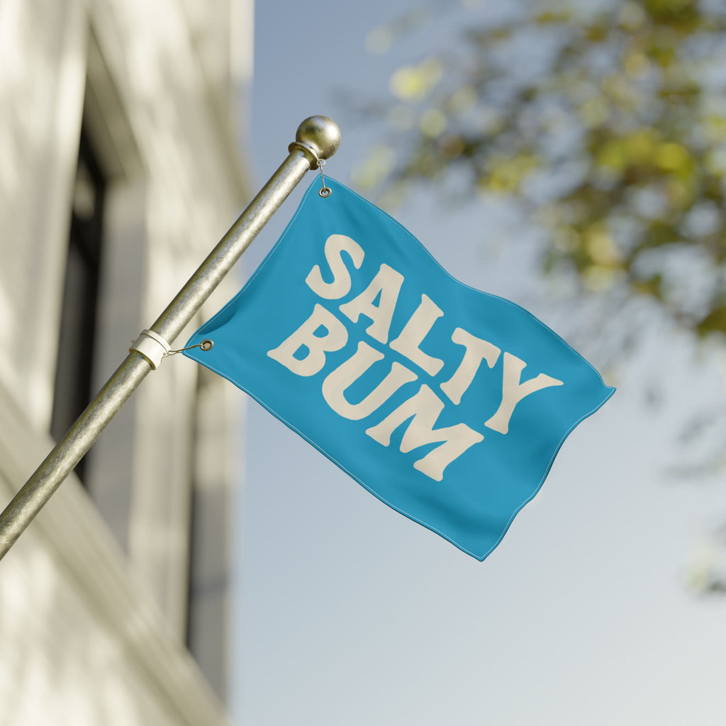 Blue flag with 'Salty Bum' text on a pole against a blurred background