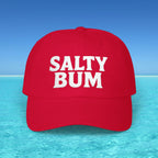 Red cap with 'Salty Bum' text on a beach background