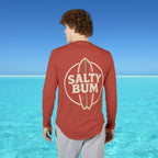 Person wearing a red 'Salty Bum' shirt with a blue ocean and sky background