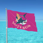 Flag with shark and bikini woman design against a blue ocean background