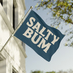 Flag with 'Salty Bum' text waving in front of a building